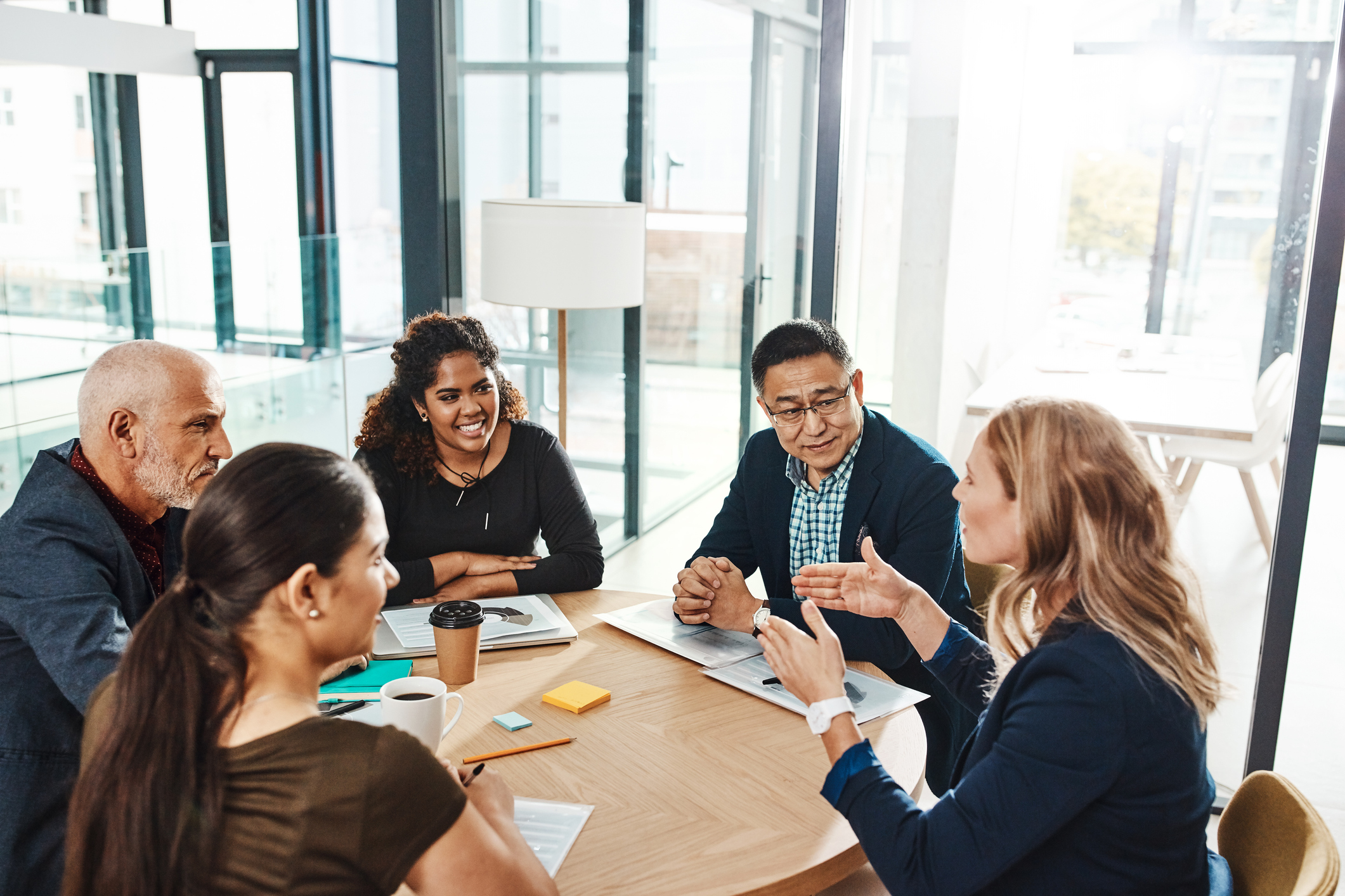 A group of coworkers gathered around a conference table.