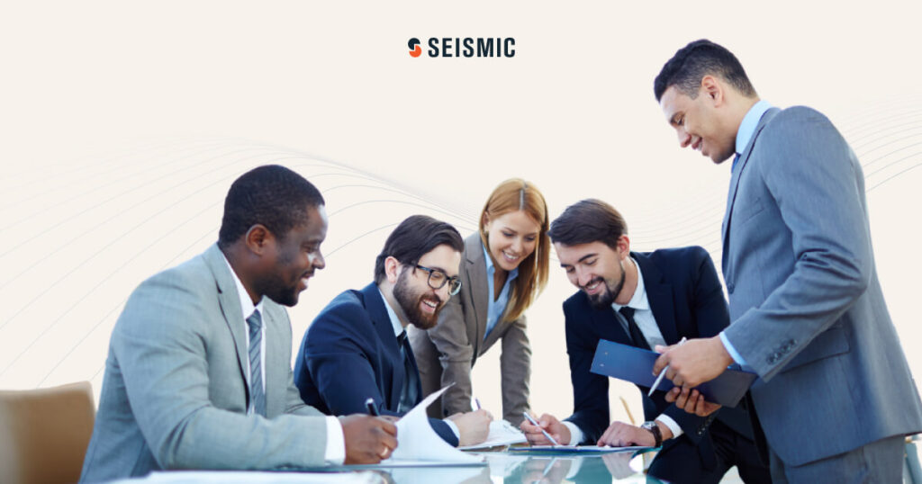 A group of smiling business people meeting around a table.