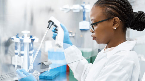 Lab technician working with a test tube.