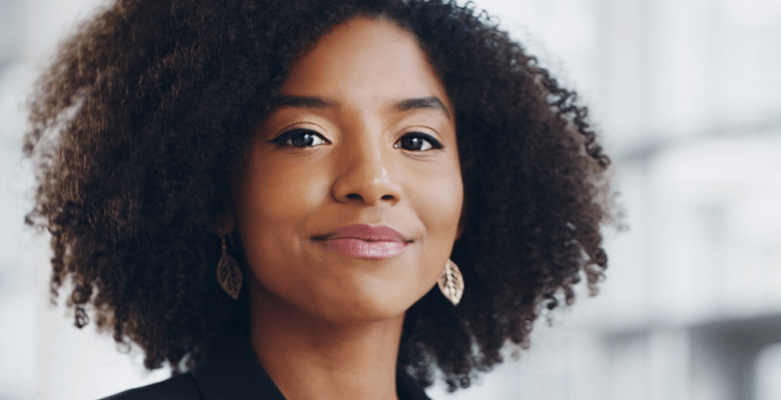 A smiling woman confidently looking inot the camera.