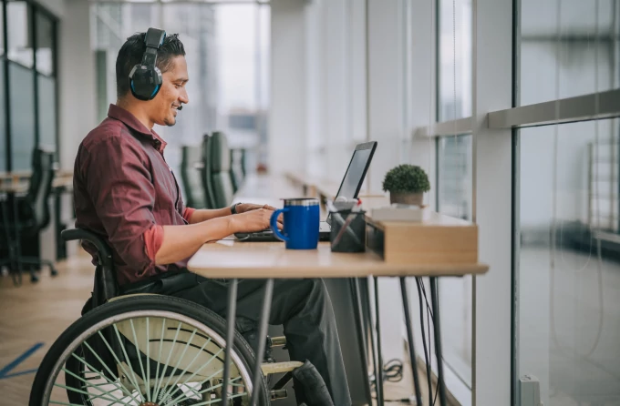 A developer who uses a wheelchair participates in a video conference.