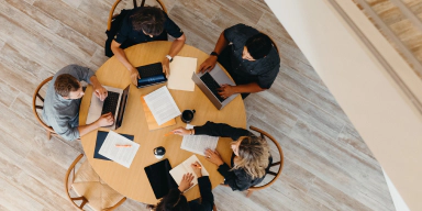 Overhead view of a group of office workers at work.