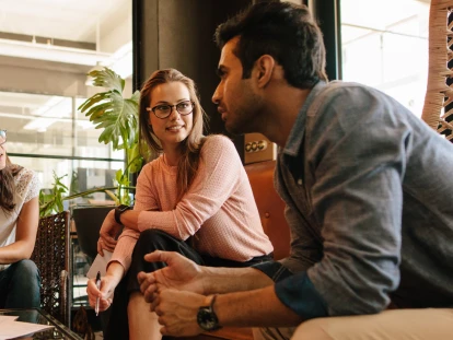 Small group of office workers meeting in a lobby.