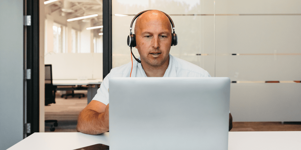 A man engaged in an online meeting.